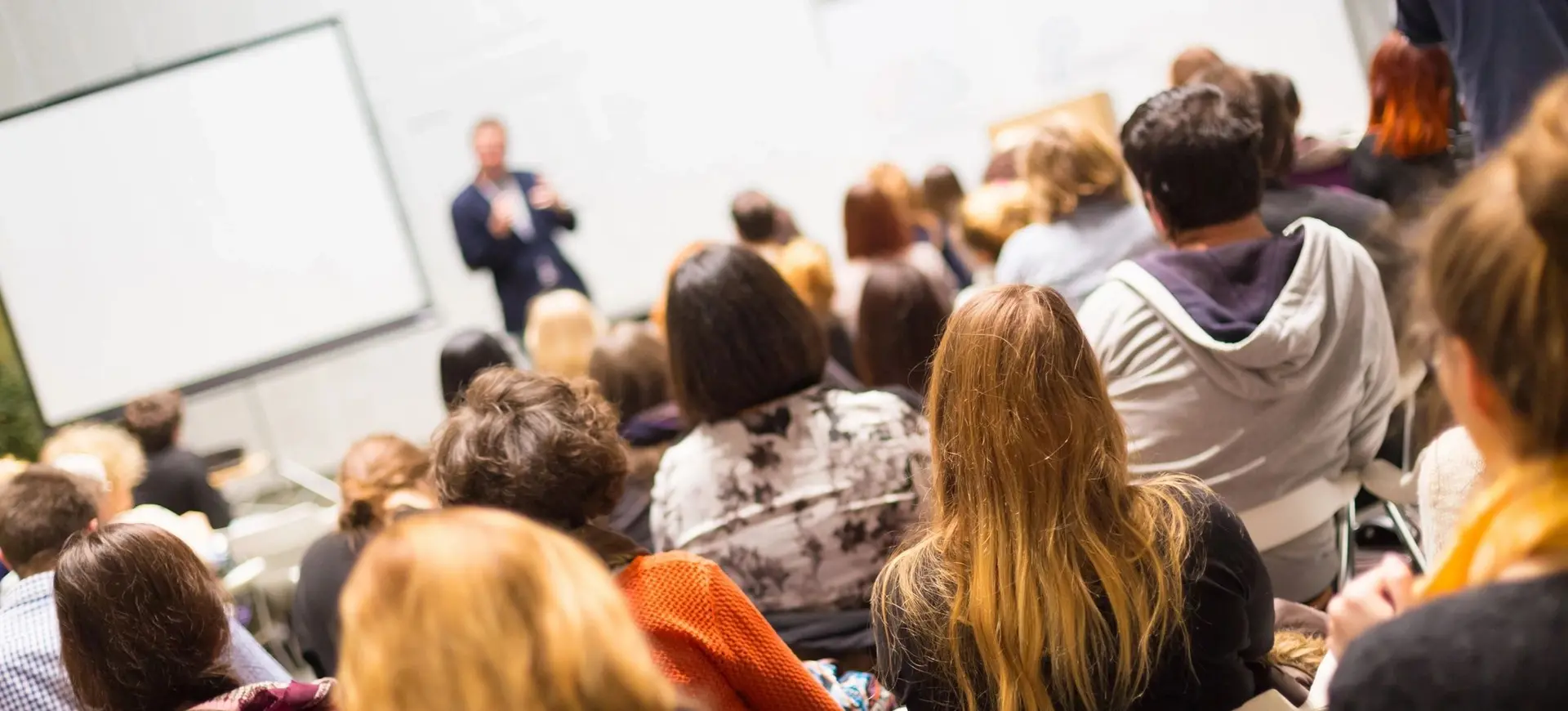 Speaker Giving a Talk seminar, Audience in the conference hall.